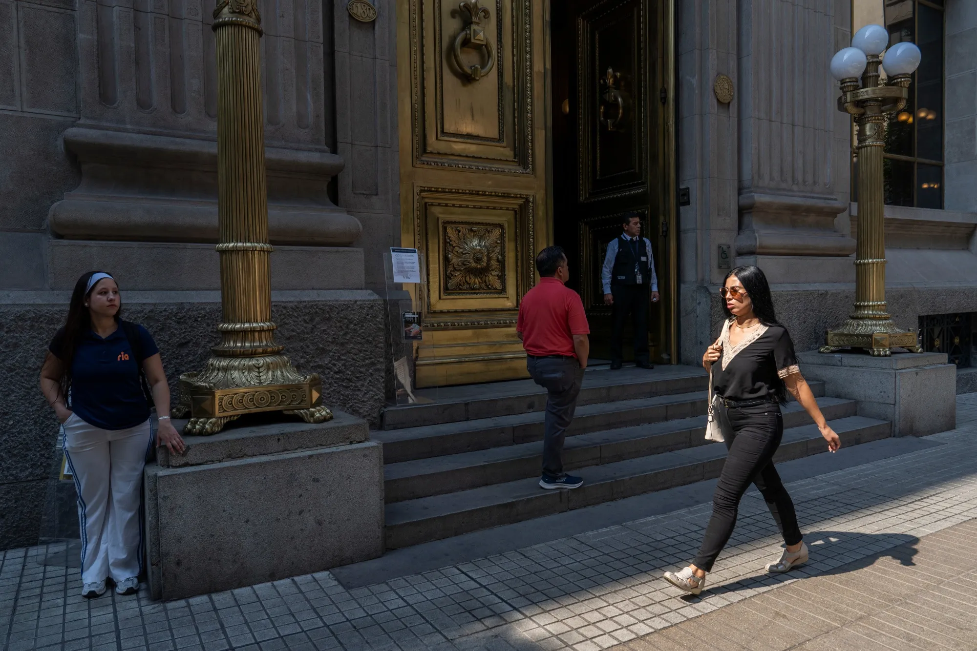 Pedestrians walk past the Central Bank of Chile in Santiago.