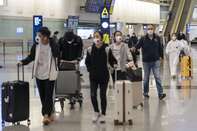 International Passengers Arrive at Hong Kong Airport Ahead of Extended Quarantine Order