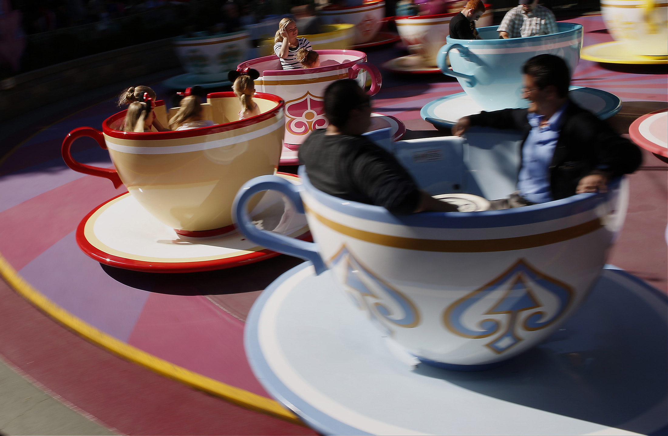 Guests ride the Tea Cups at Walt Disney Co.'s Disneyland Park in Anaheim, California.
