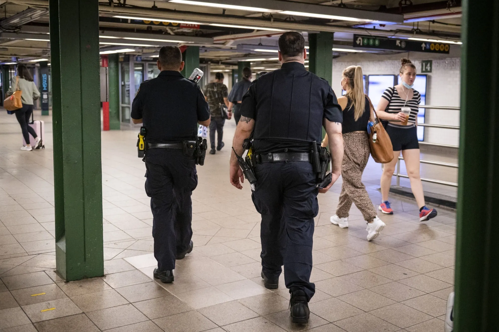 Police&nbsp;officers walk through the Union Square subway station on July 2, 2021. A new report&nbsp;advocates for a decreased focus on policing low-level offenses such as fare evasion or public sleeping, and an increase in unarmed personnel trained to respond to homelessness and mental health crises.&nbsp;