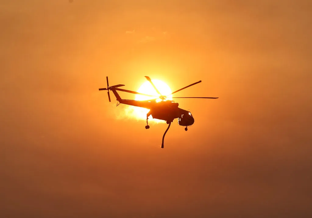 A firefighting helicopter as the Lake Fire burns inear Los Olivos, California.