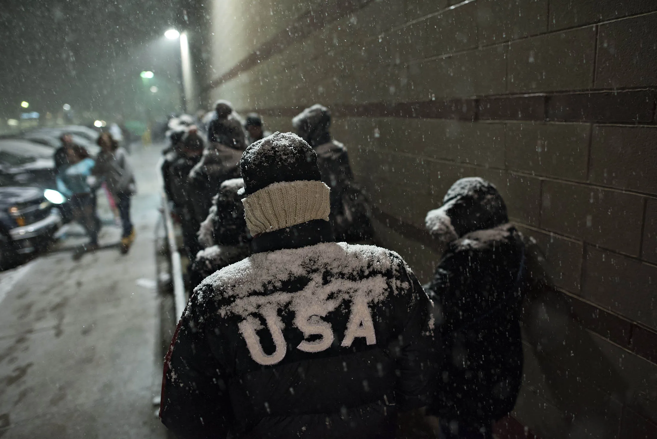 Shoppers wait in line as snow falls outside a Target store ahead of Black Friday in Ohio.
