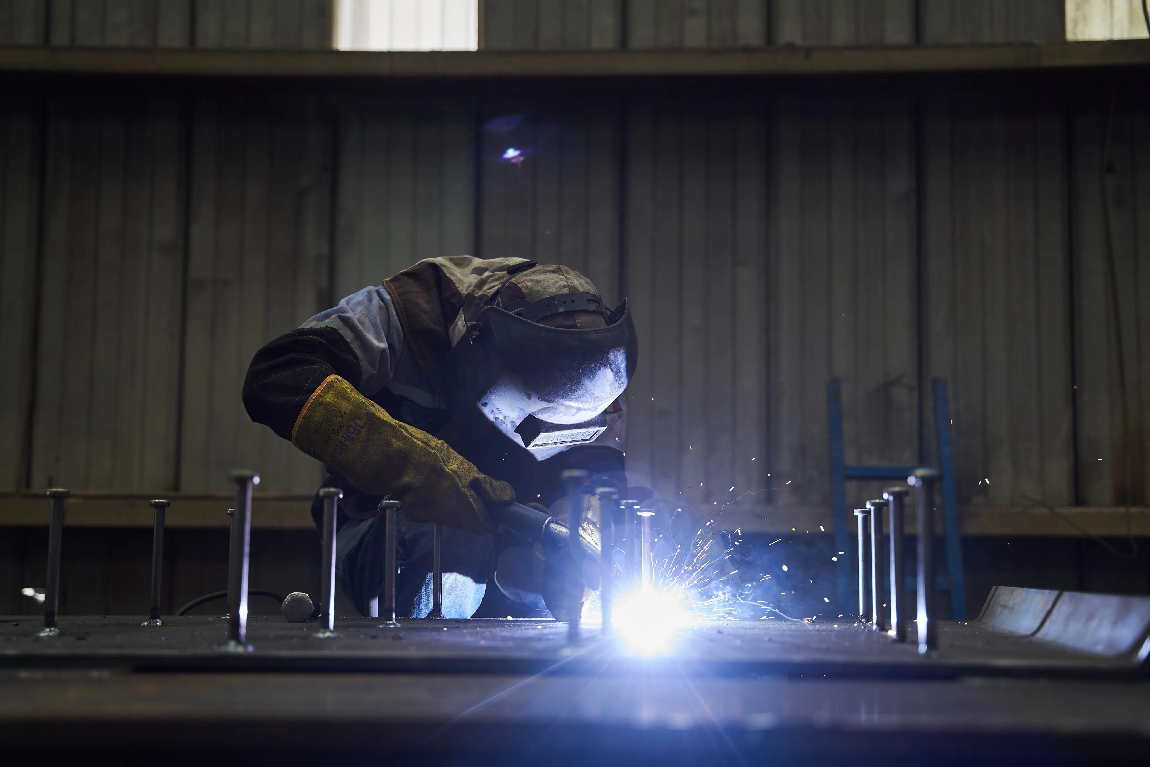 A worker welds bolts on to a sheet at a steel manufacturing plant in San Luis Potosi,&nbsp;Mexico.