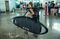 A tourist carries her surf boad at Ngurah Rai airport in Bali. Photographer: Agung Parameswara/Getty Images