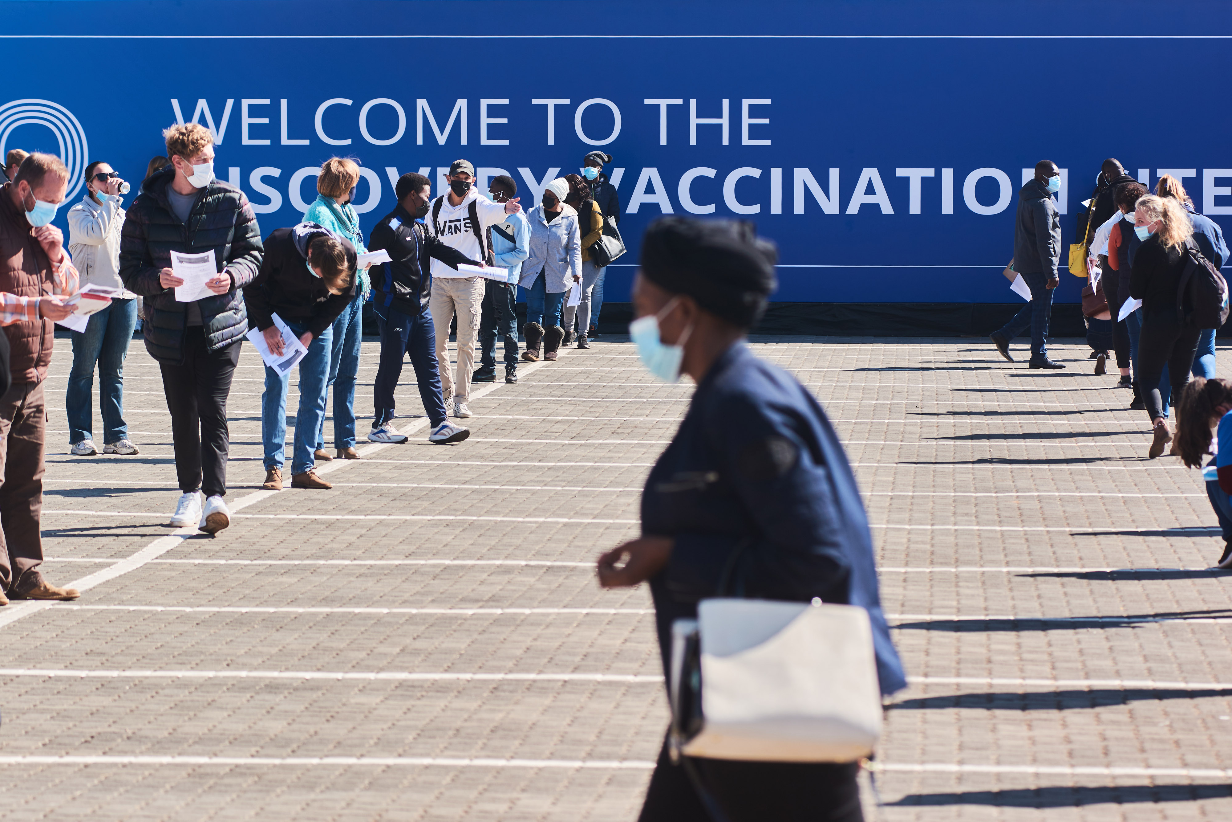 Residents wait in line to register at a Discovery Ltd. mass vaccination site in Johannesburg, South Africa.