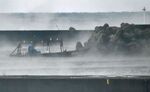 A wooden boat is moored in the city of Yurihonjo after washing ashore carrying eight men in Japan's Akita Prefecture on Nov. 24