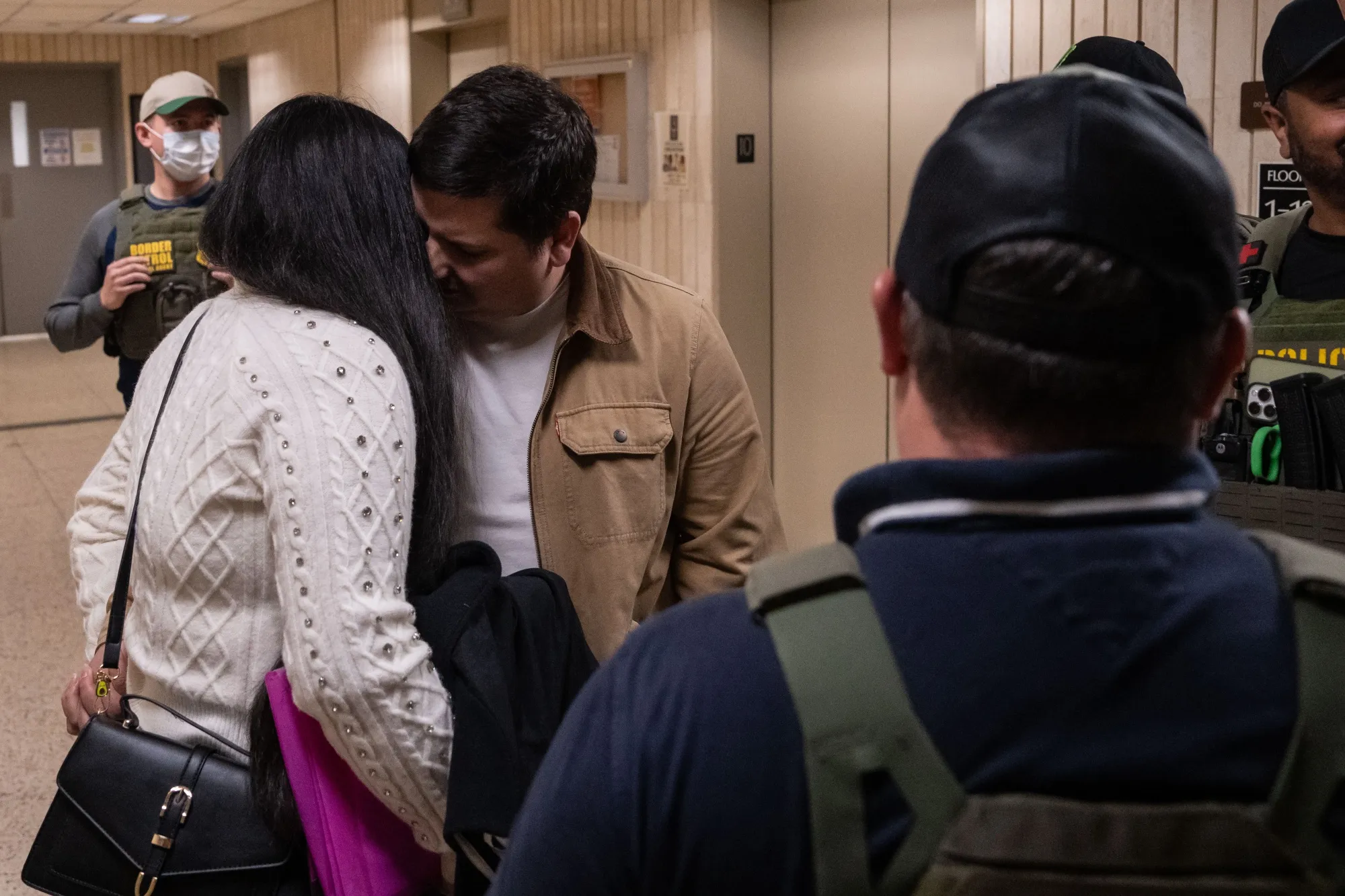 A man says goodbye to a woman as Federal agents detain him following an immigration court hearing at Jacob K. Javits Federal Building in New York, on June 10.