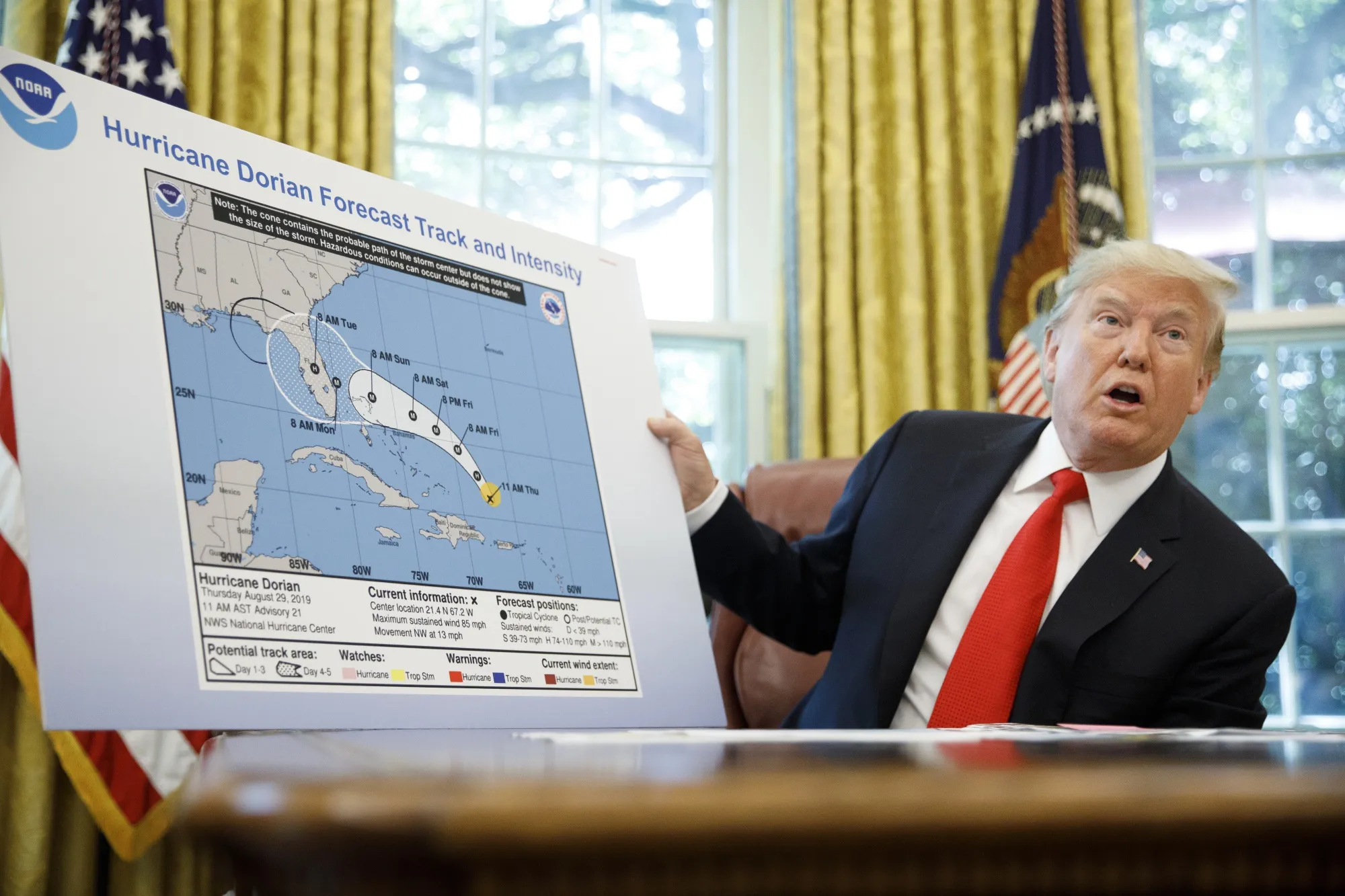 Donald Trump speaks to members of the media about Hurricane Dorian in 2019.