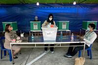 A woman casts her ballot during advance voting in Bangkok on May 7.