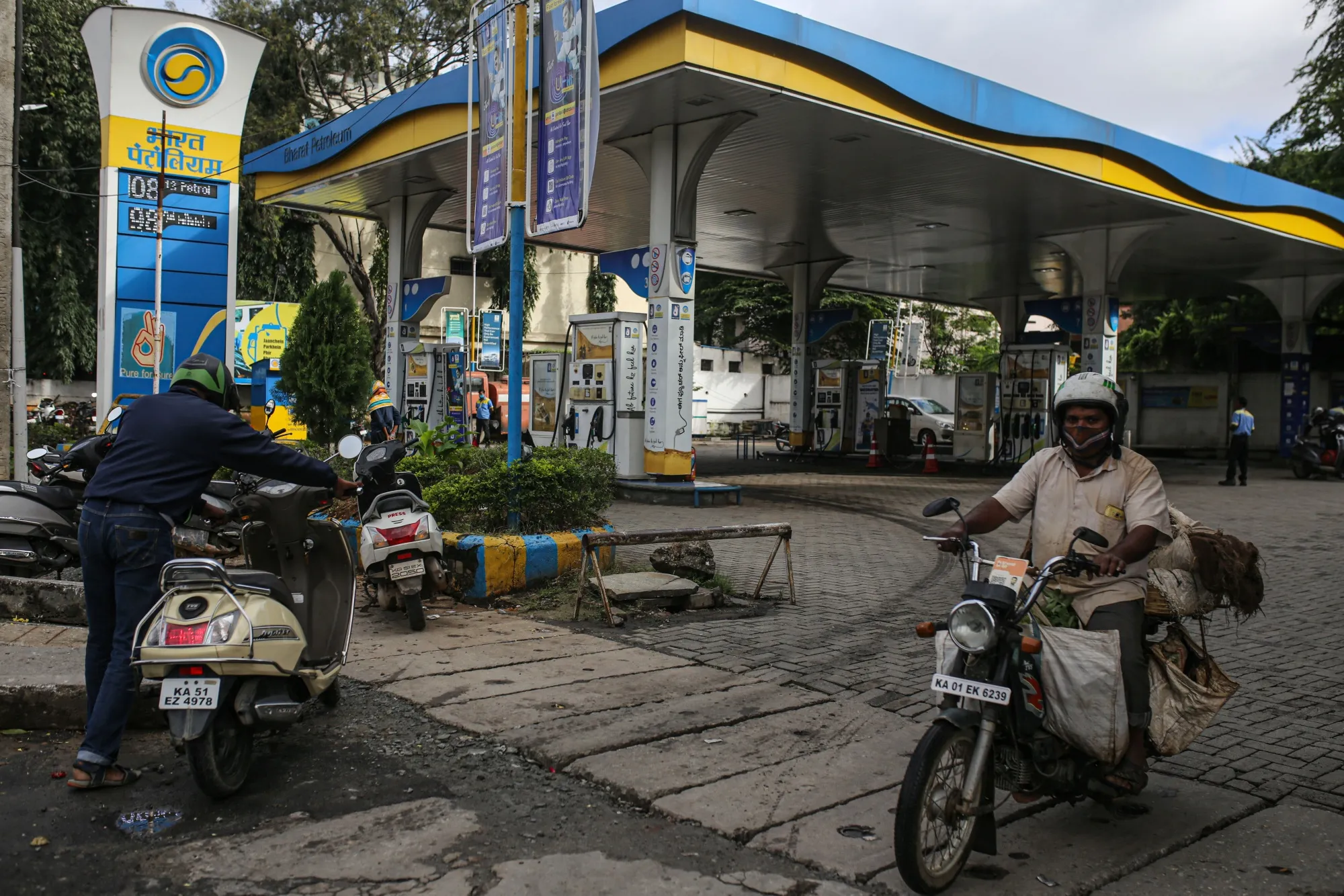 A motorcyclist rides out of a Bharat Petroleum gas station in Bengaluru, India.