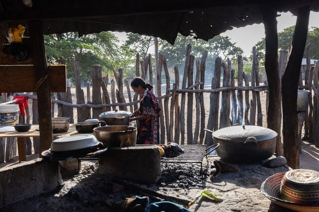 A resident cooks a meal in an outdoor kitchen.