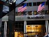 Pedestrians pass in front of BlackRock Inc. headquarters in New York.
