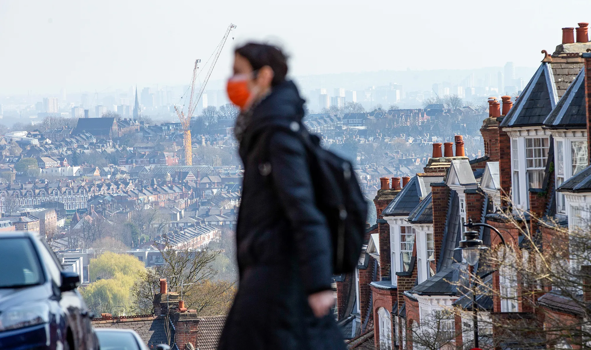 A pedestrian wearing a protective face mask walks in London on March 27.&nbsp;