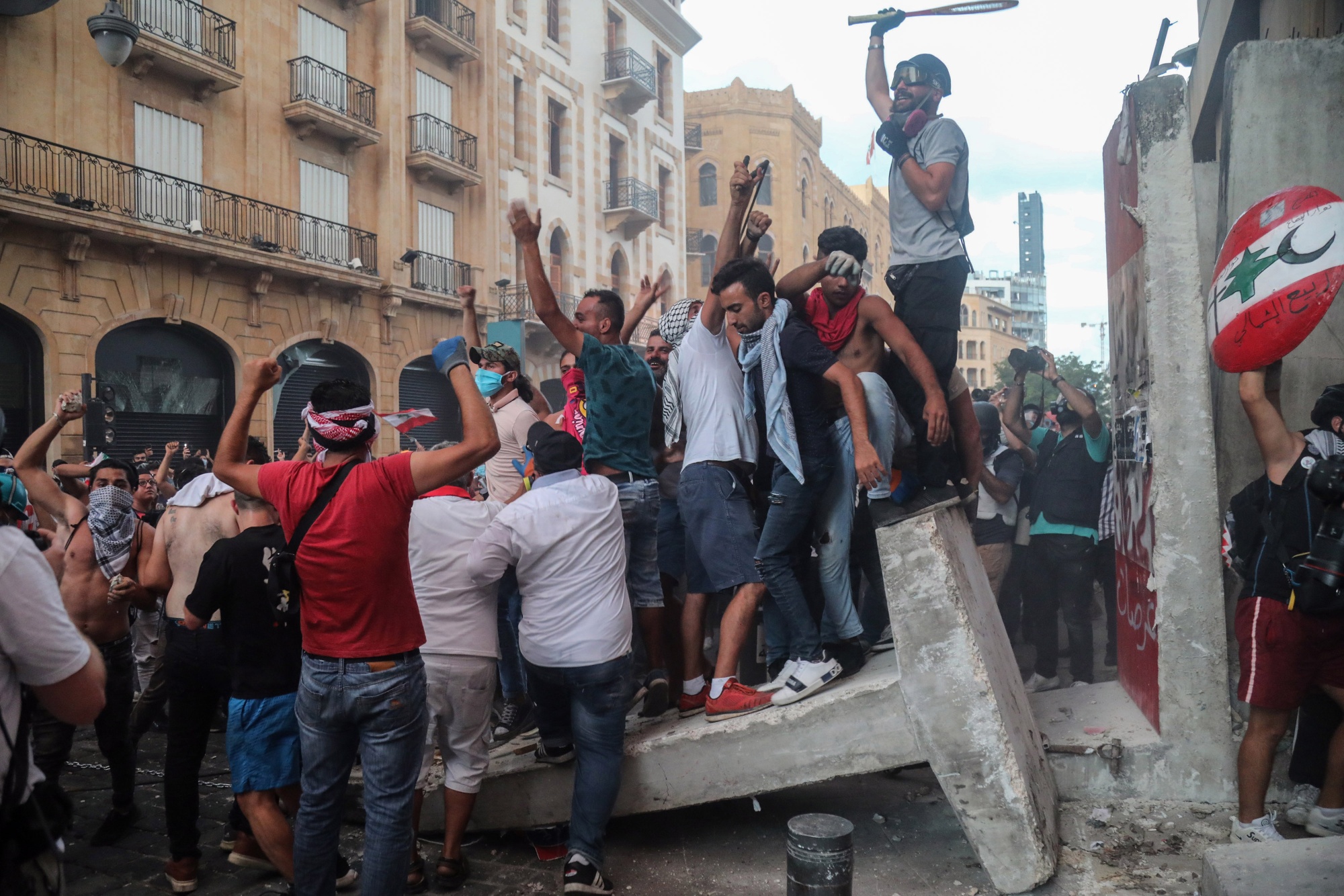 Protesters remove concrete barriers blocking a parliament entrance during an anti-government protest in Beirut, on Aug. 10.