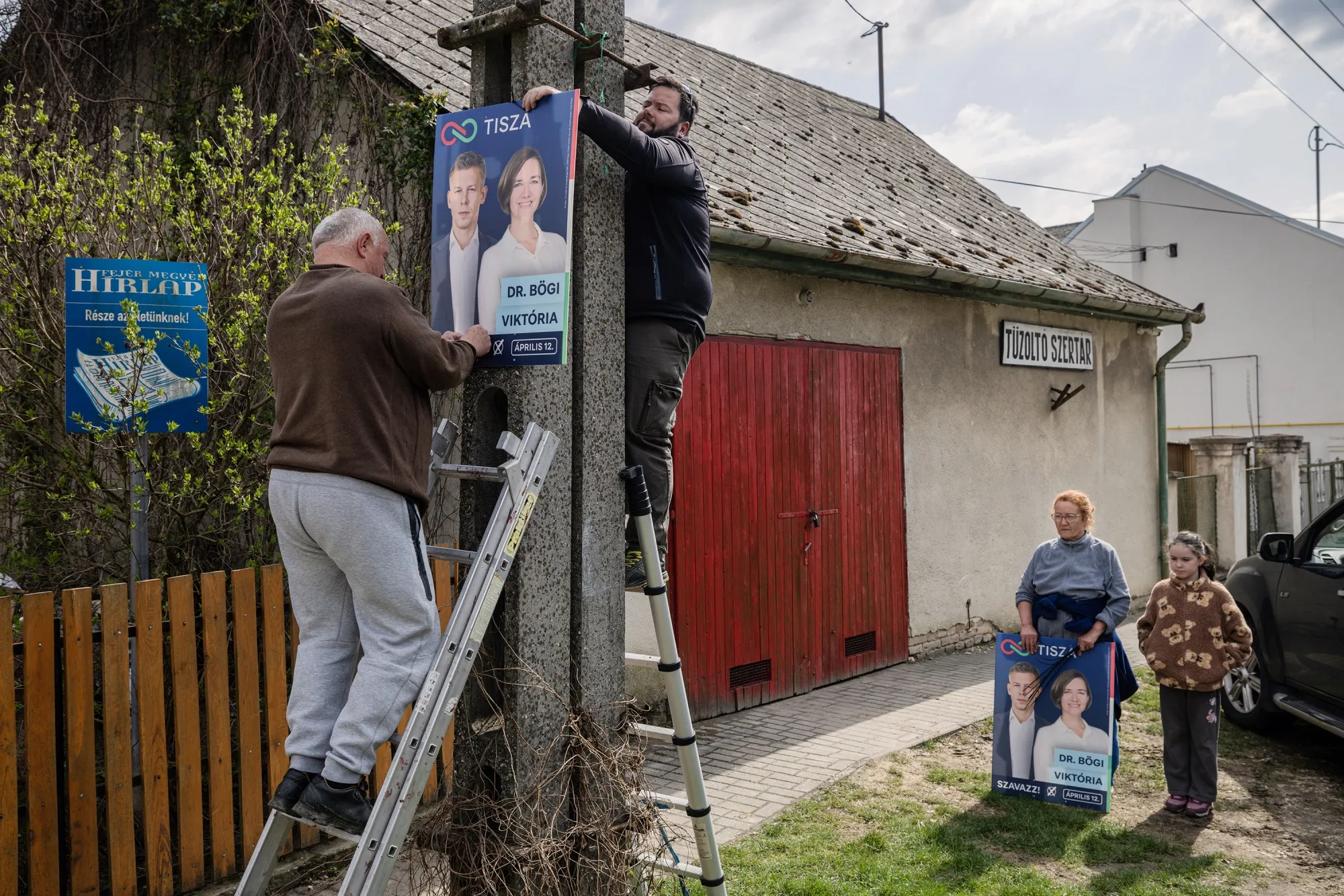 Opposition supporters hang Tisza campaign posters in the village of Vértesacsa, near Hungarian Prime Minister Viktor Orban’s birthplace&nbsp;of Székesfehérvár.