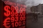 Exchange rates in the window of a currency exchange bureau in Moscow on Feb. 24.