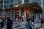 Pedestrians walk past the Bank of America Tower in New York. 