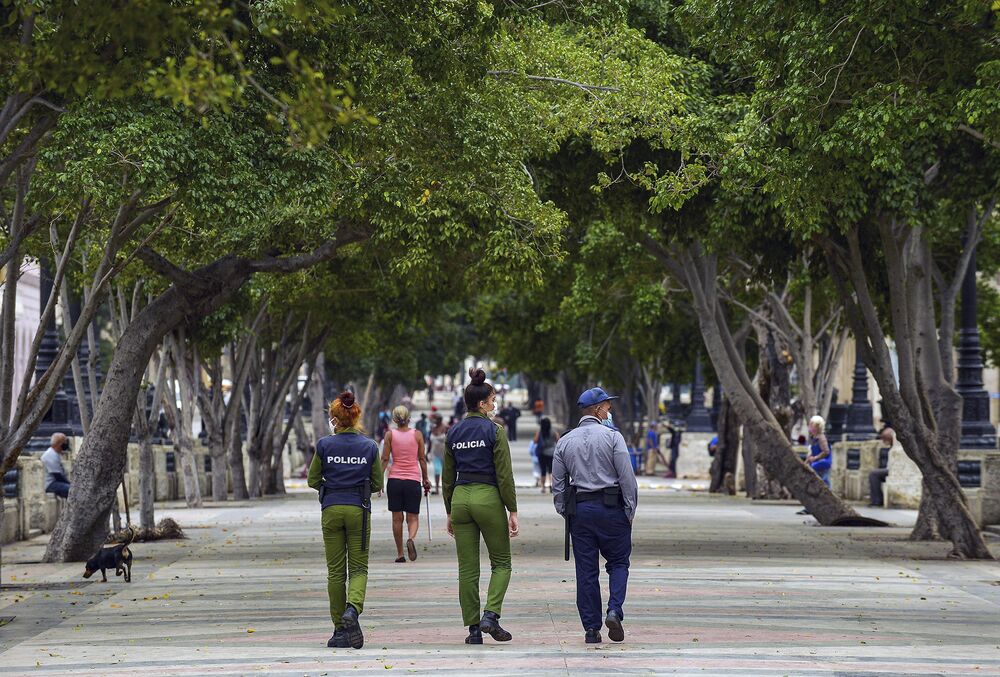 Police officers walk along El Paseo del Prado street in Havana, on Nov. 15.