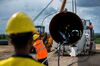 Workers bend a section of gas pipeline on the EUGAL site in Gellmersdorf, Germany.