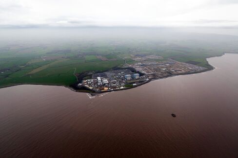Hinkley Point B nuclear power station, operated by Electricite de France SA's (EDF), left, stands near to groundworks for Hinkley Point C near Bridgwater.