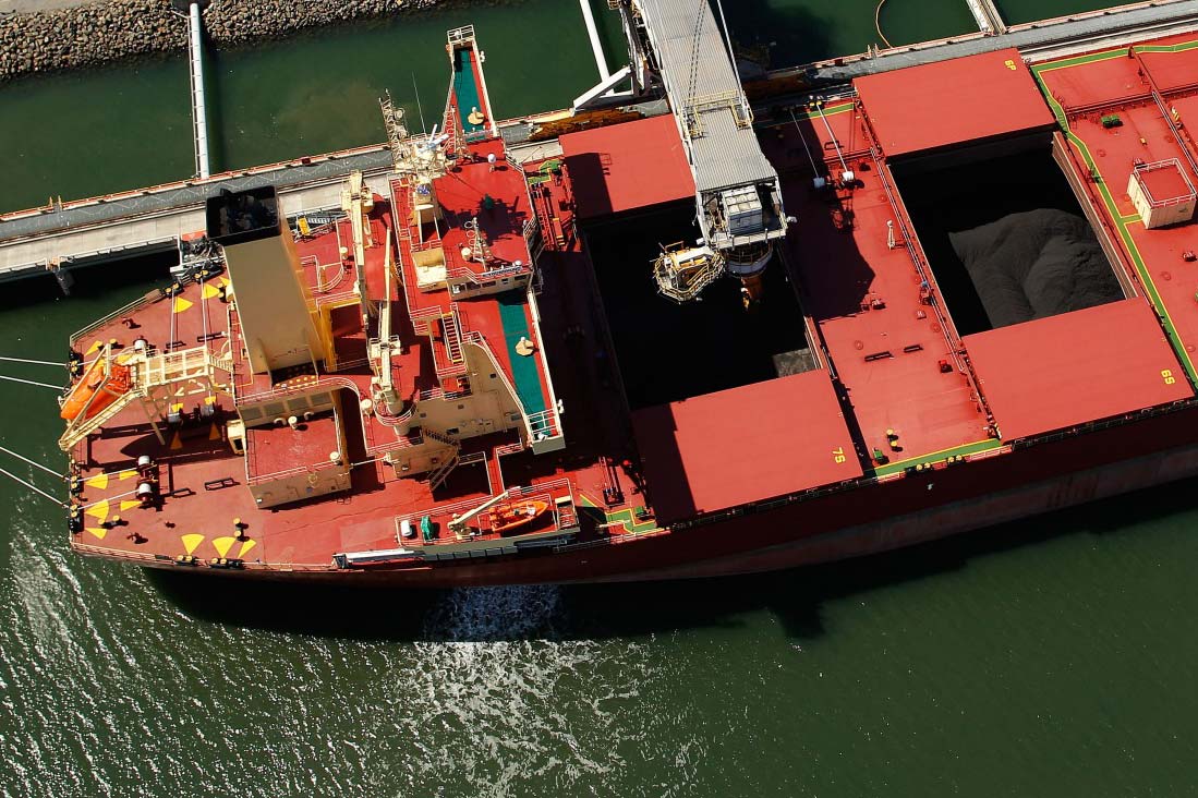 A bulk carrier is loaded with coal at the Newcastle Coal Terminal in this aerial photograph taken in Newcastle, Australia.
