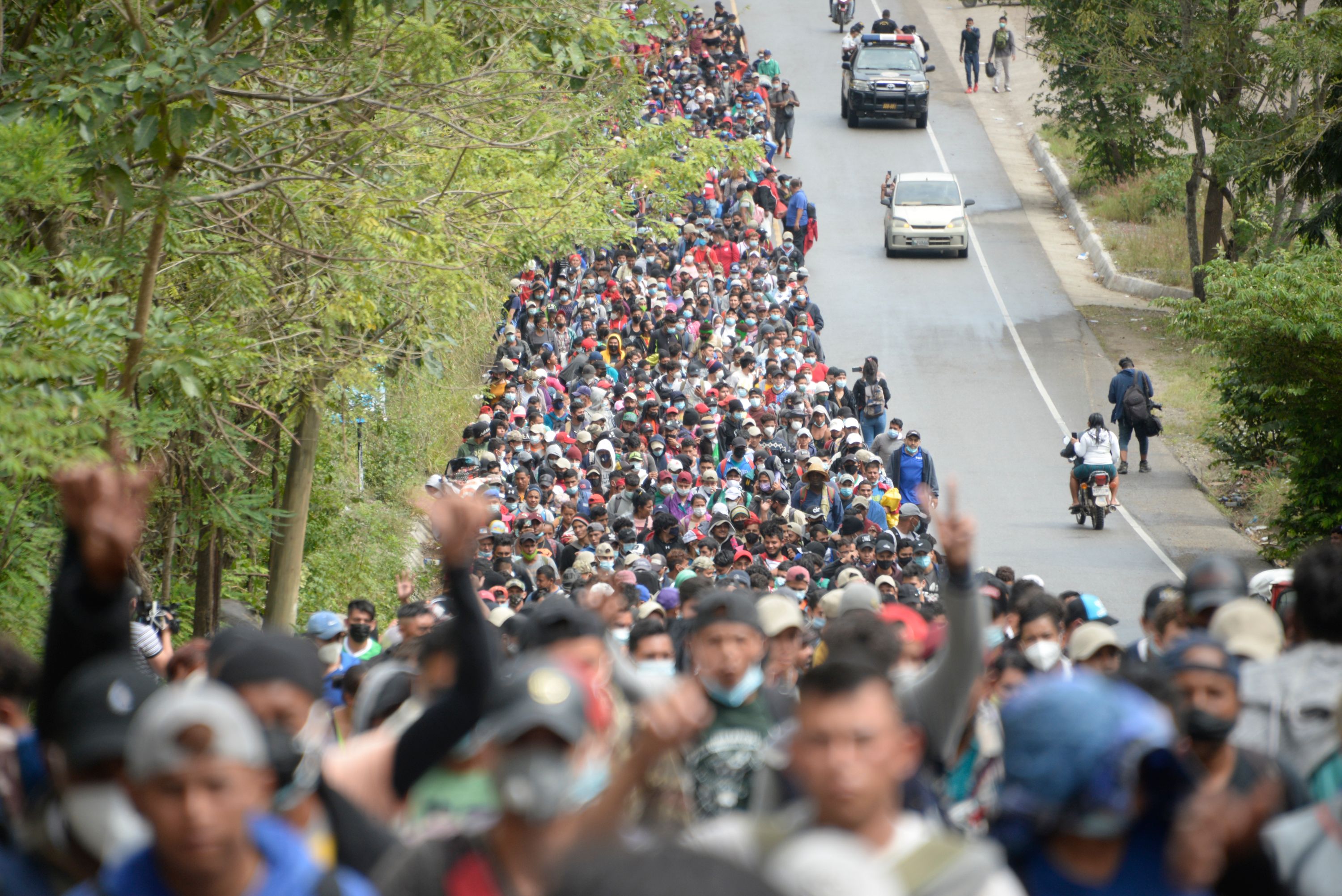 Honduran migrants, part of a caravan heading to the United States, walk along a road in Guatemala on January 16.