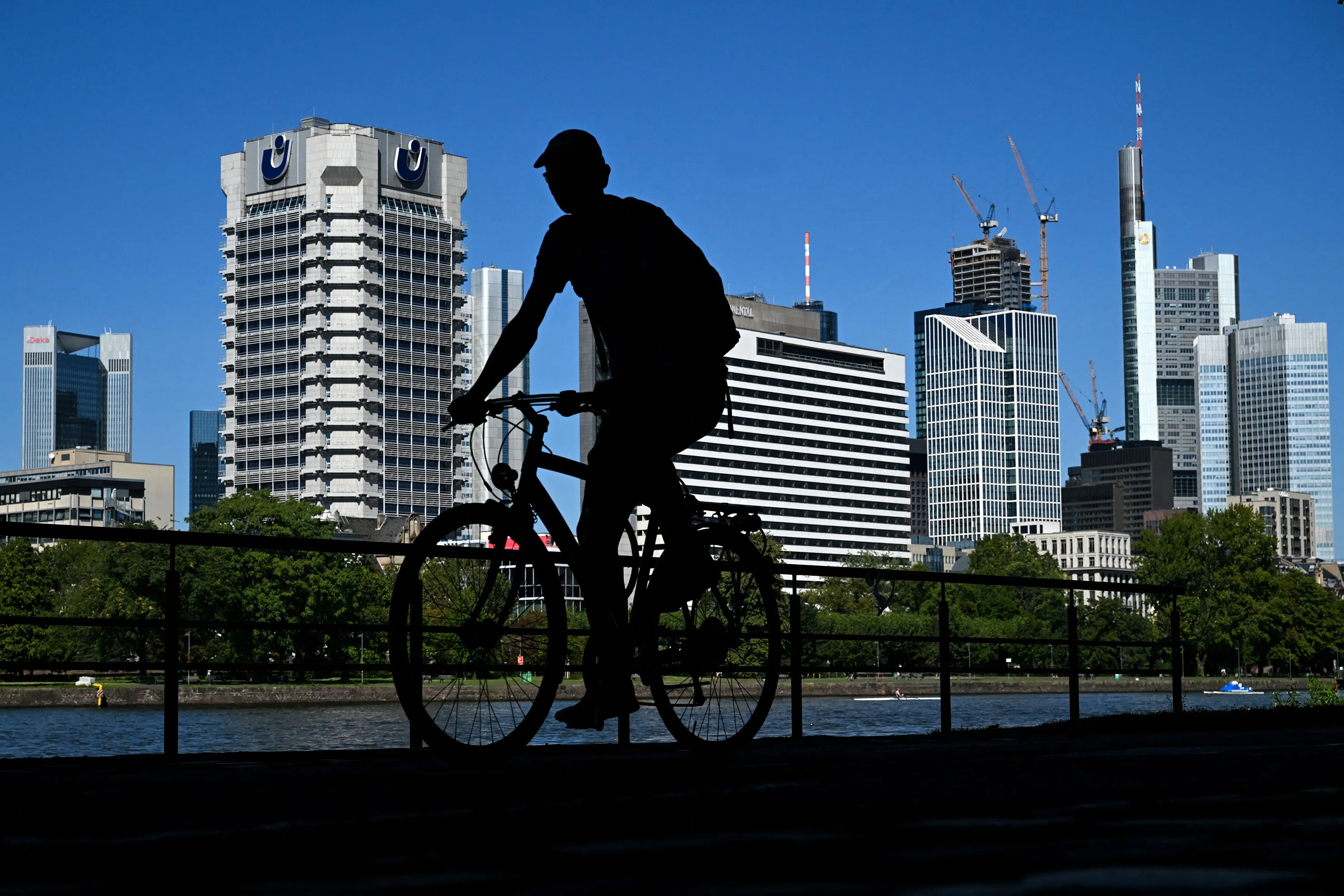 A man rides a bicycle along the Main river embankment&nbsp;in Frankfurt, Germany, on Sept. 6.