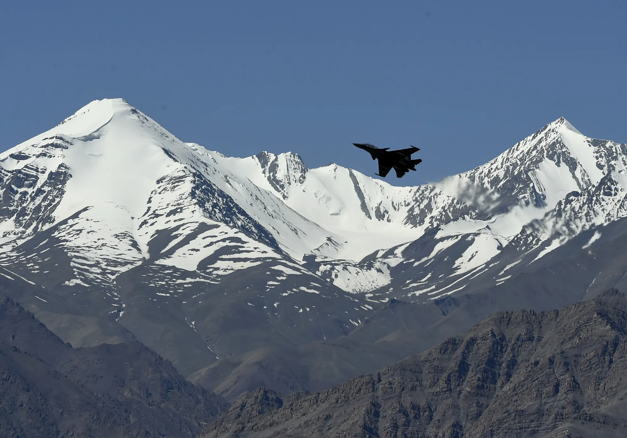 An Indian fighter jet flies over a mountain range near Leh, the joint capital of the union territory of Ladakh, on June 22.&nbsp;
