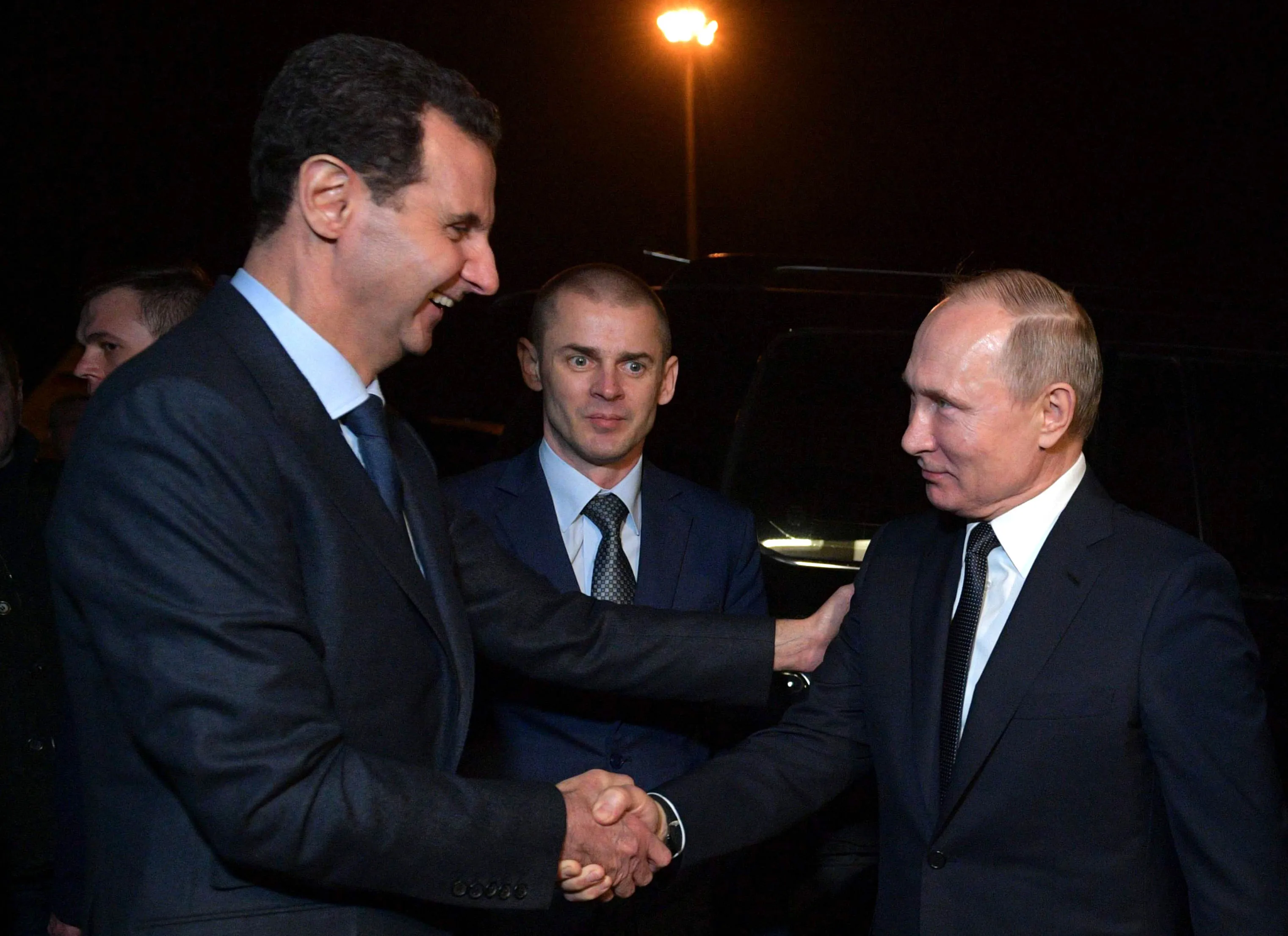 Vladimir Putin and Bashar al-Assad shake in Damascus in 2020.