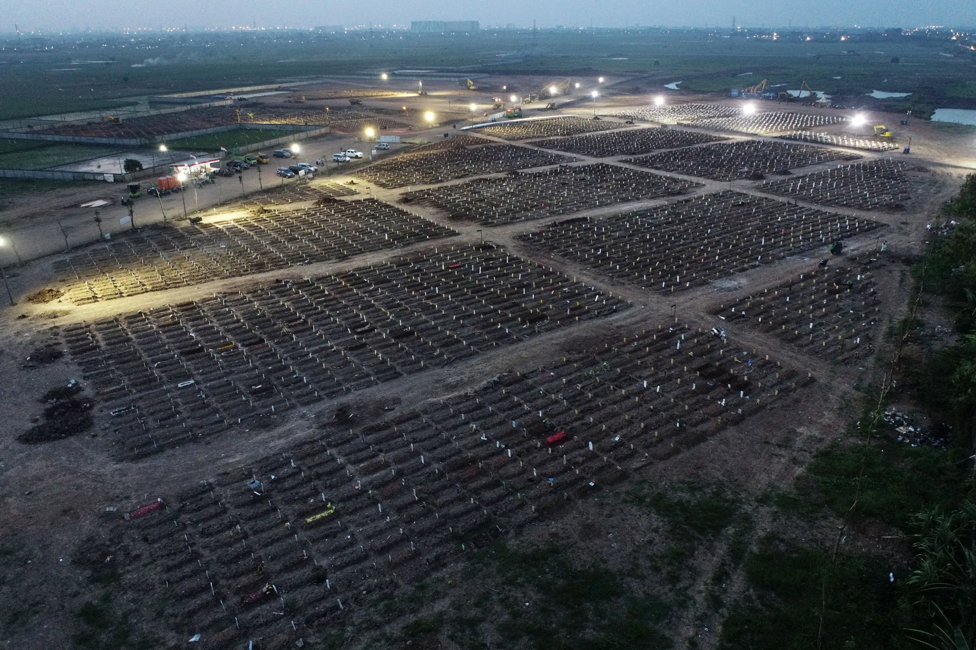 Headstones and crosses mark the graves of Covid-19 fatalities at the Rorotan cemetery in Jakarta, Indonesia.