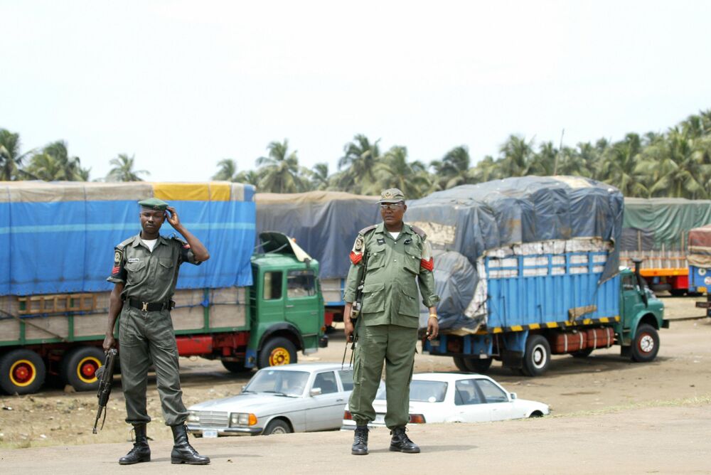 Nigerian security stand guard near the Nigerian-Benin border.
