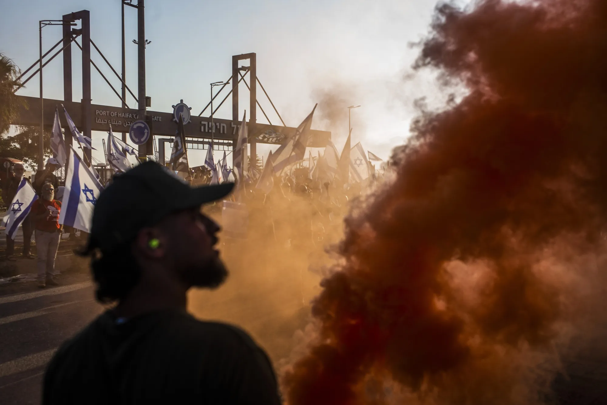 Israeli activists of the “Brothers in Arms” group block the gate of the Haifa port during a protest against the Israeli government.