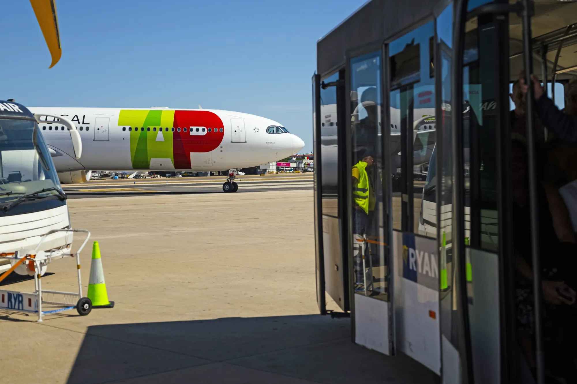 A bus departs the gate to TAP SA passenger jet at Lisbon Airport.