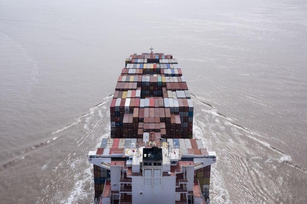 The ZIM Integrated Shipping Services Ltd. Chicago container ship sails out of the Yangshan Deepwater Port in this aerial photograph taken in Shanghai, China, on Monday, March 23, 2020. 