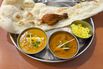 Indian Thali Platter with Curries, Naan, Rice, and Tandoori Chicken