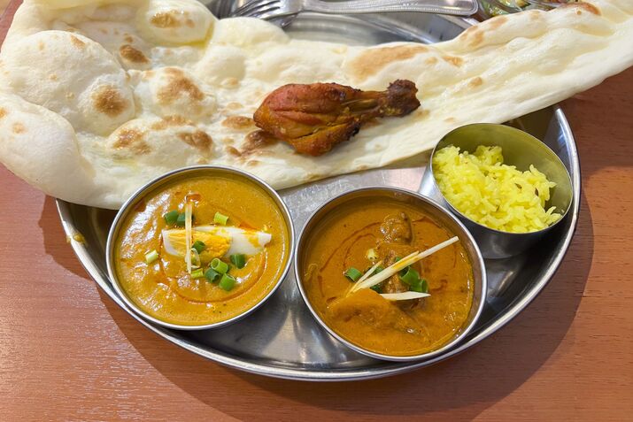 Indian Thali Platter with Curries, Naan, Rice, and Tandoori Chicken