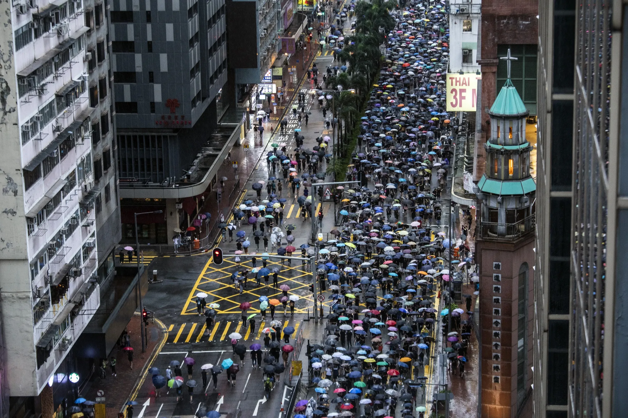 Demonstrators march along Hennessy Road in Hong Kong.