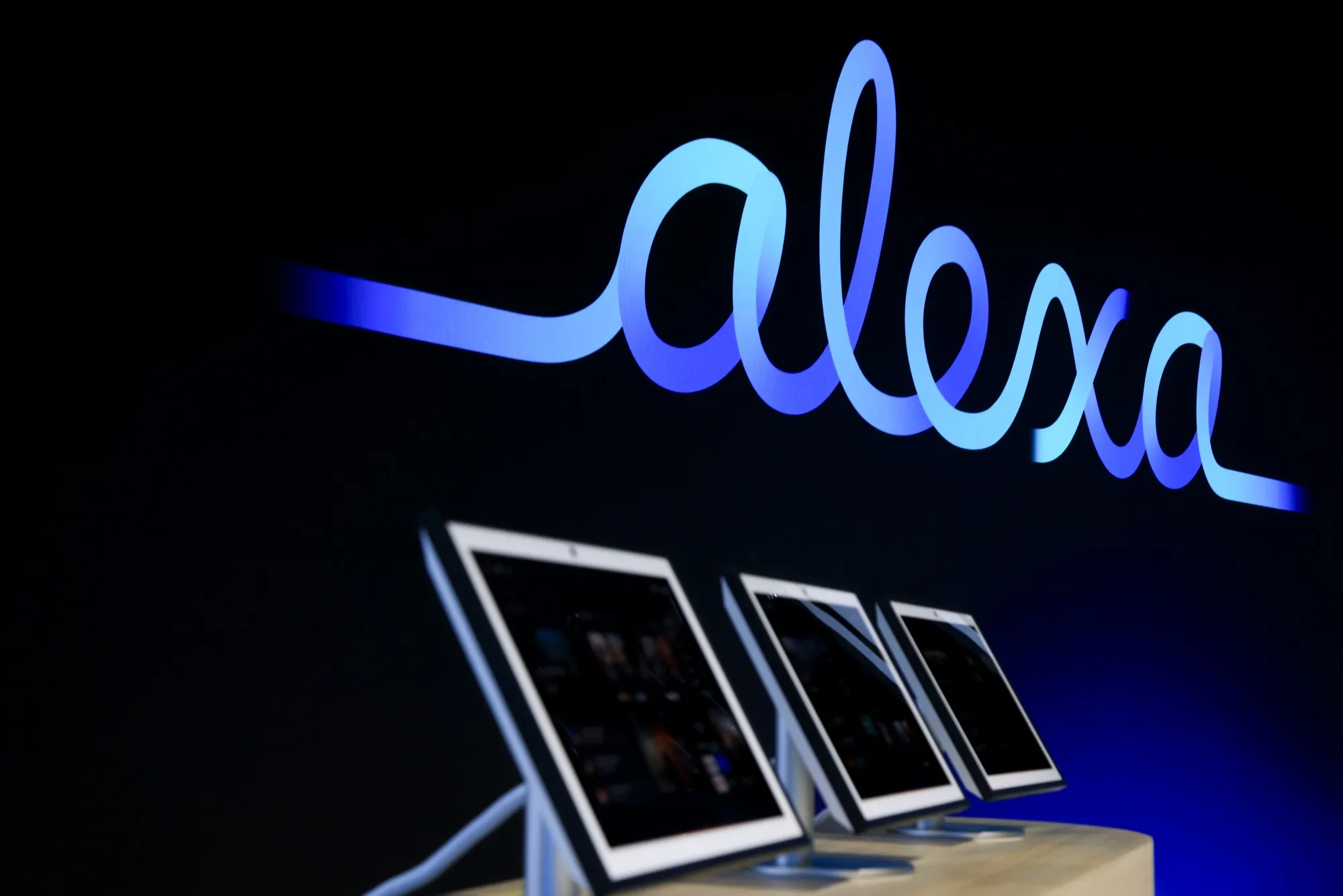 Tablets showcase Alexa+ software features during an unveiling event in New York.