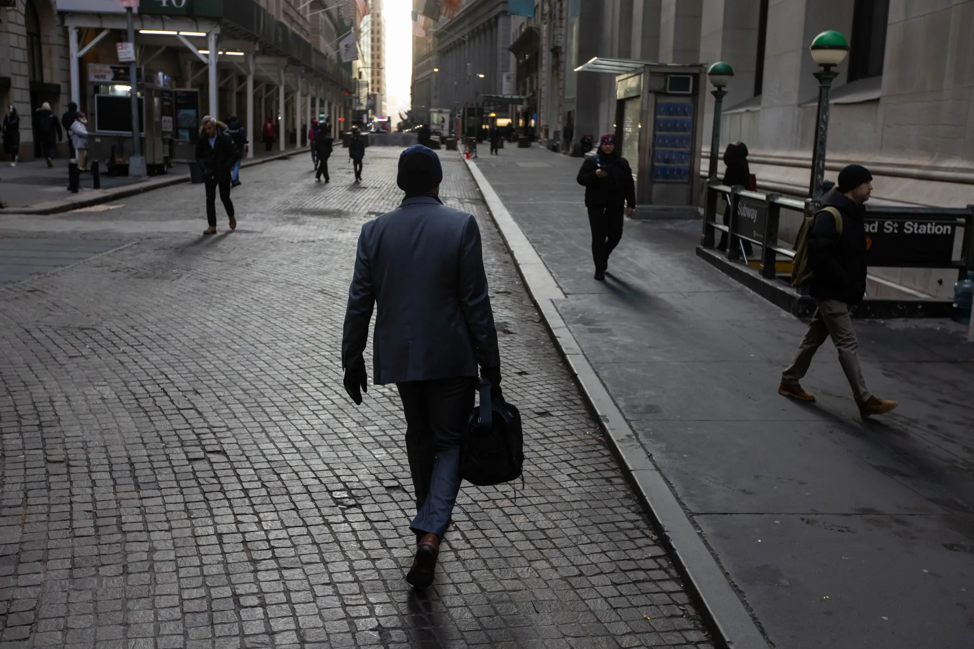 Pedestrians on Wall Street near the New York Stock Exchange (NYSE) in New York.