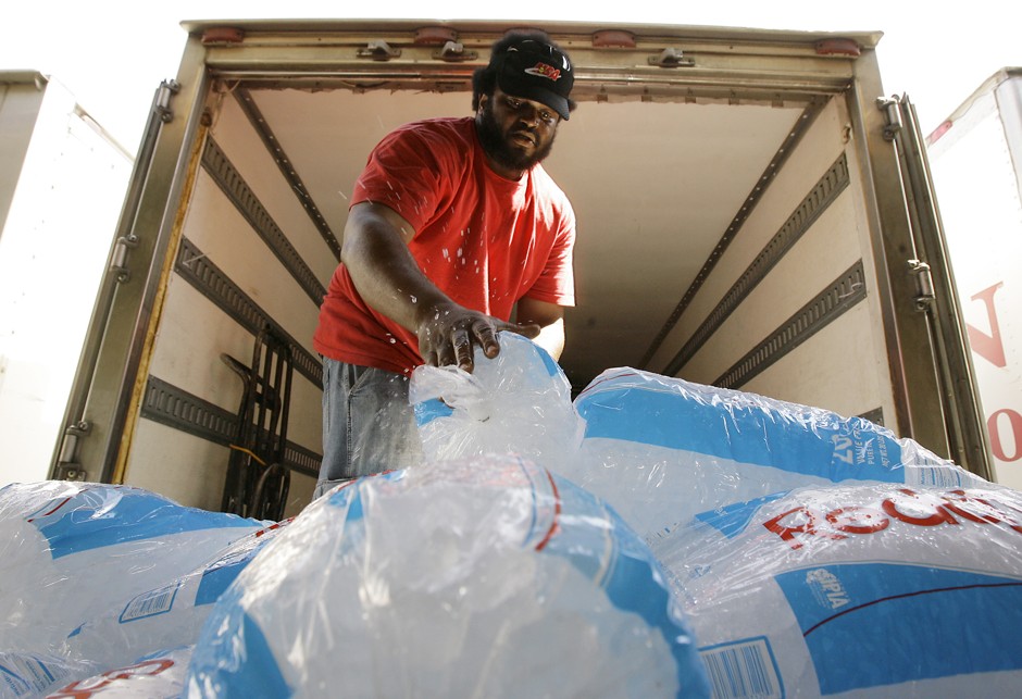 Danny McFadden, of Phoenix, a driver for AZ Iceman, loads up a pallet of bagged ice as temperatures were predicted to hit 115 during a heat wave in July 2007.