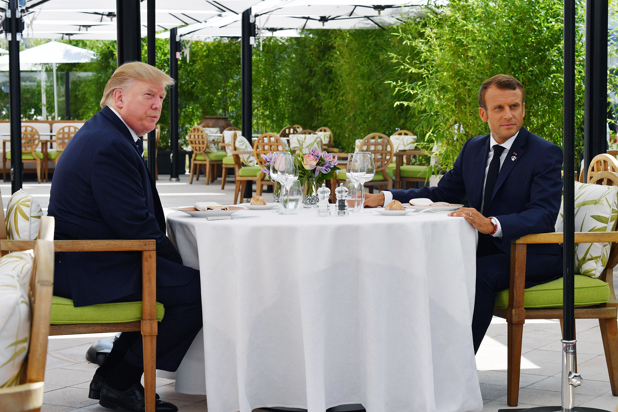 President Trump sits to lunch with President Macron at the Hotel du Palais in Biarritz on Saturday.