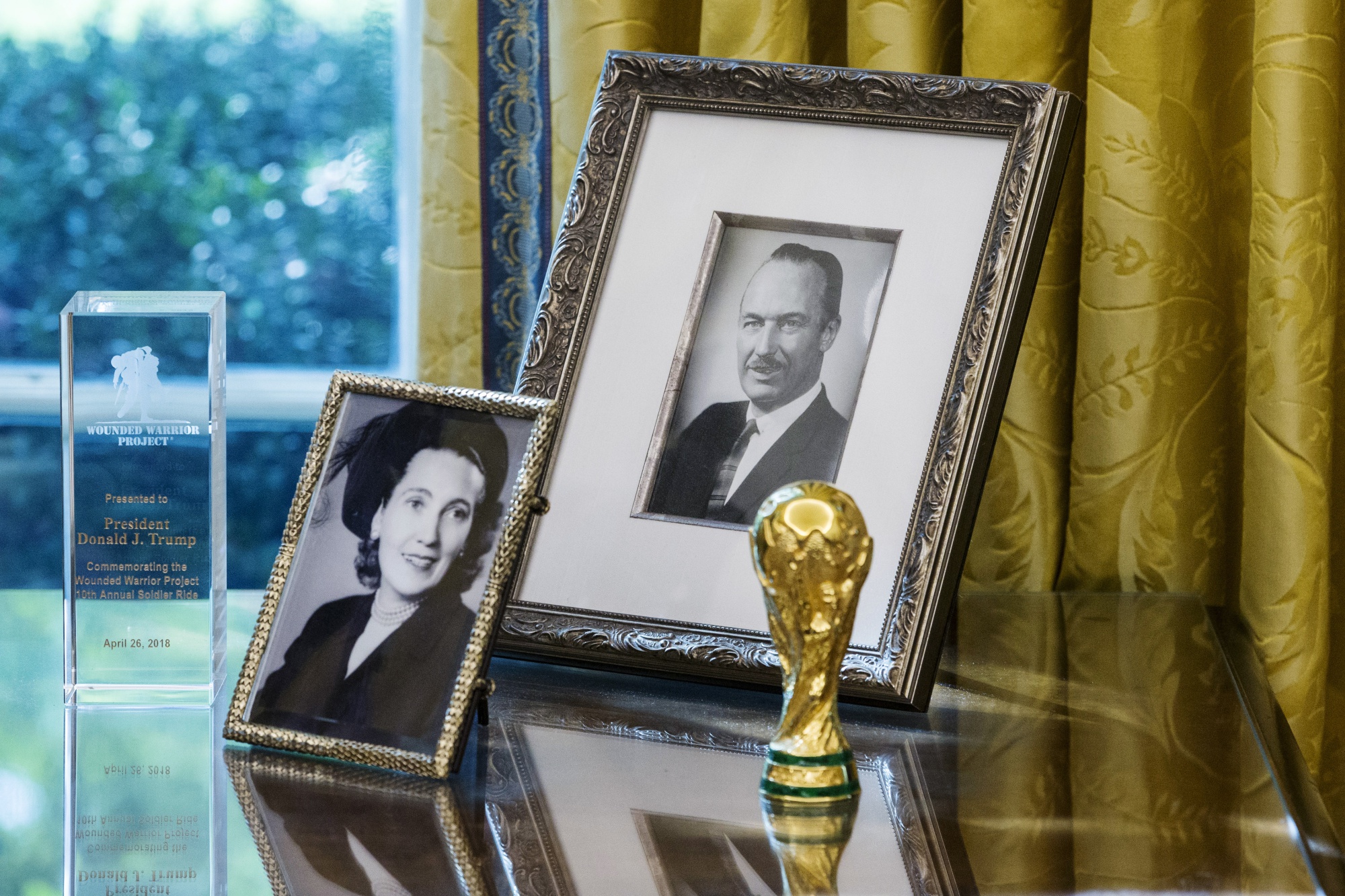 Photographs of Donald Trump's parents, Mary Anne MacLeod Trump and Fred Trump, sit on a desk in the Oval Office at the White House in Washington, D.C.