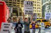 Protestors with a sign that says Heather Bresch Mylan The Face of Greed at the company’s New York City offices.