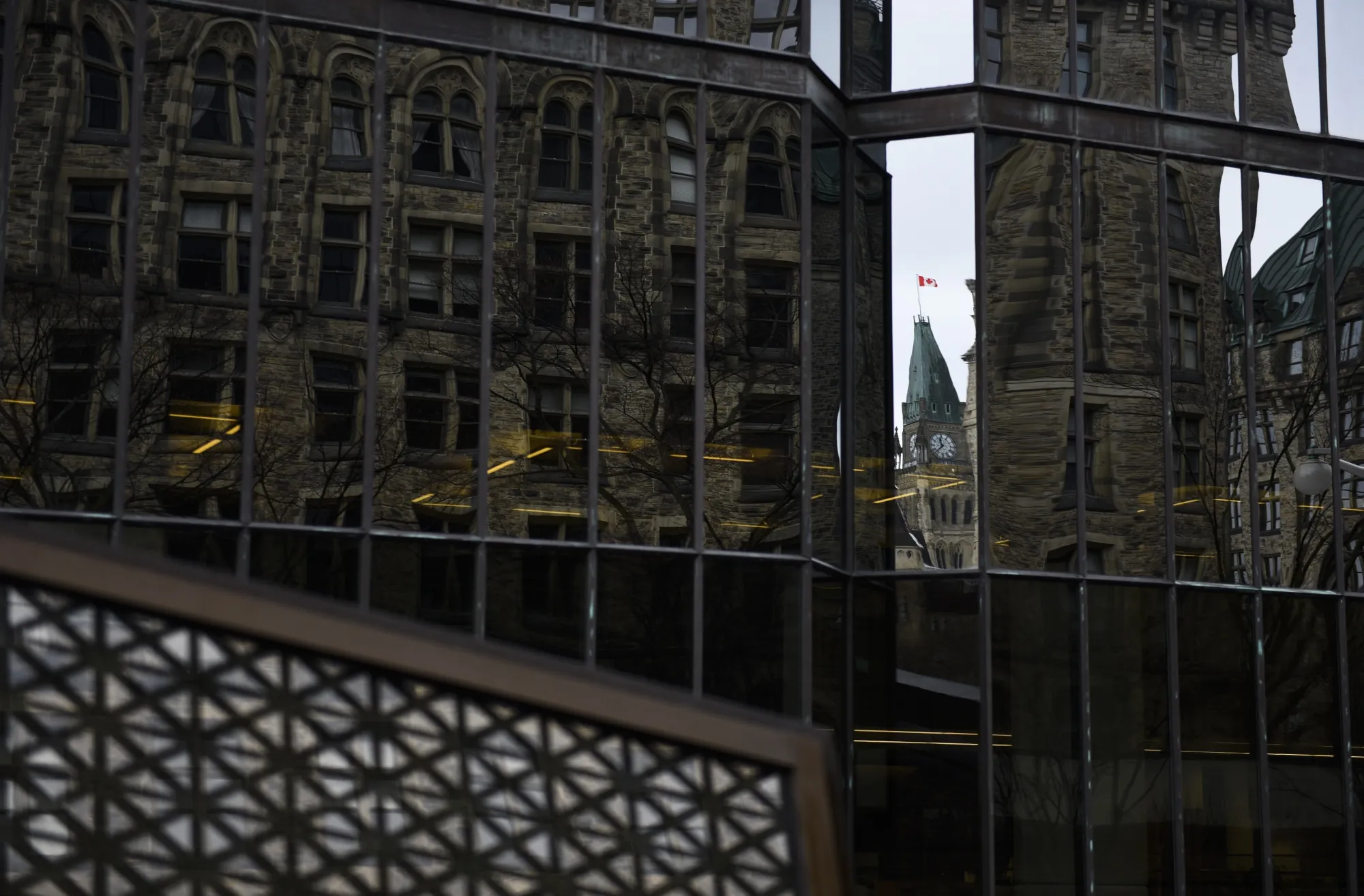 The Peace Tower is reflected in a window at the Bank of Canada. Ottawa is home to a high concentration of federal government workers.