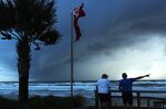 Two men observe a squall caused by hurricane Dorian looming in the Atlantic Ocean.&nbsp;