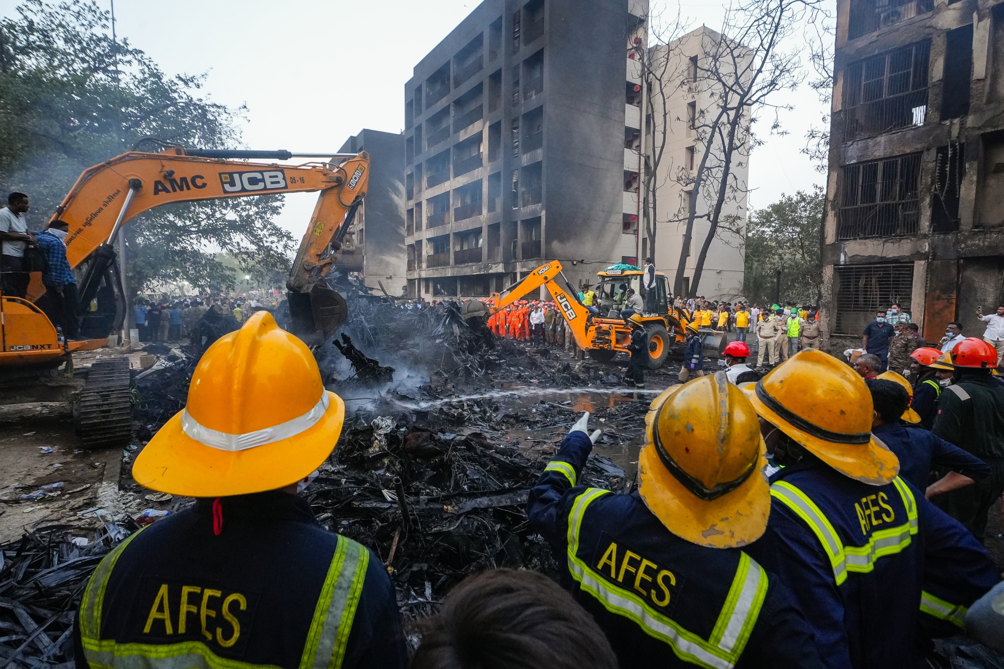 Officials work at the site where Air India flight 171 crashed in a residential area near the airport in Ahmedabad, India, on June 12.