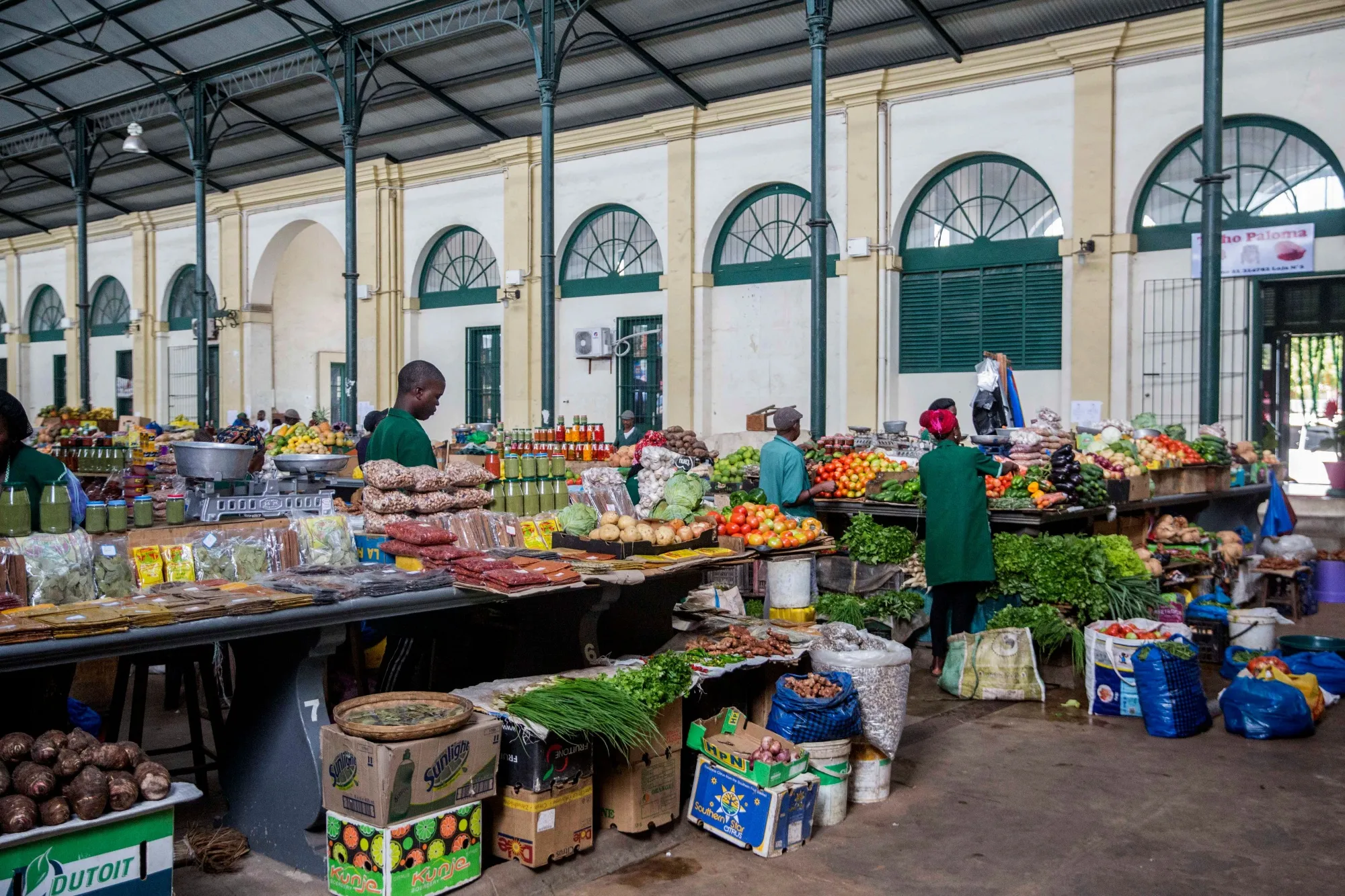 Workers prepare merchandise at the central market in Maputo.