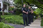 Police officers stand guard outside the home of Justice Brett Kavanaugh in anticipation of an abortion-rights demonstration on May 18.