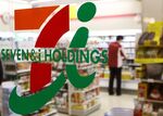 An employee is seen working behind the logo of Seven &amp; I Holdings Co. at a 7-Eleven convenience store in Tokyo, Japan, on Thursday, April 3, 2014. Seven &amp; I forecasted a 4.7 percent increase in profit this fiscal year.
