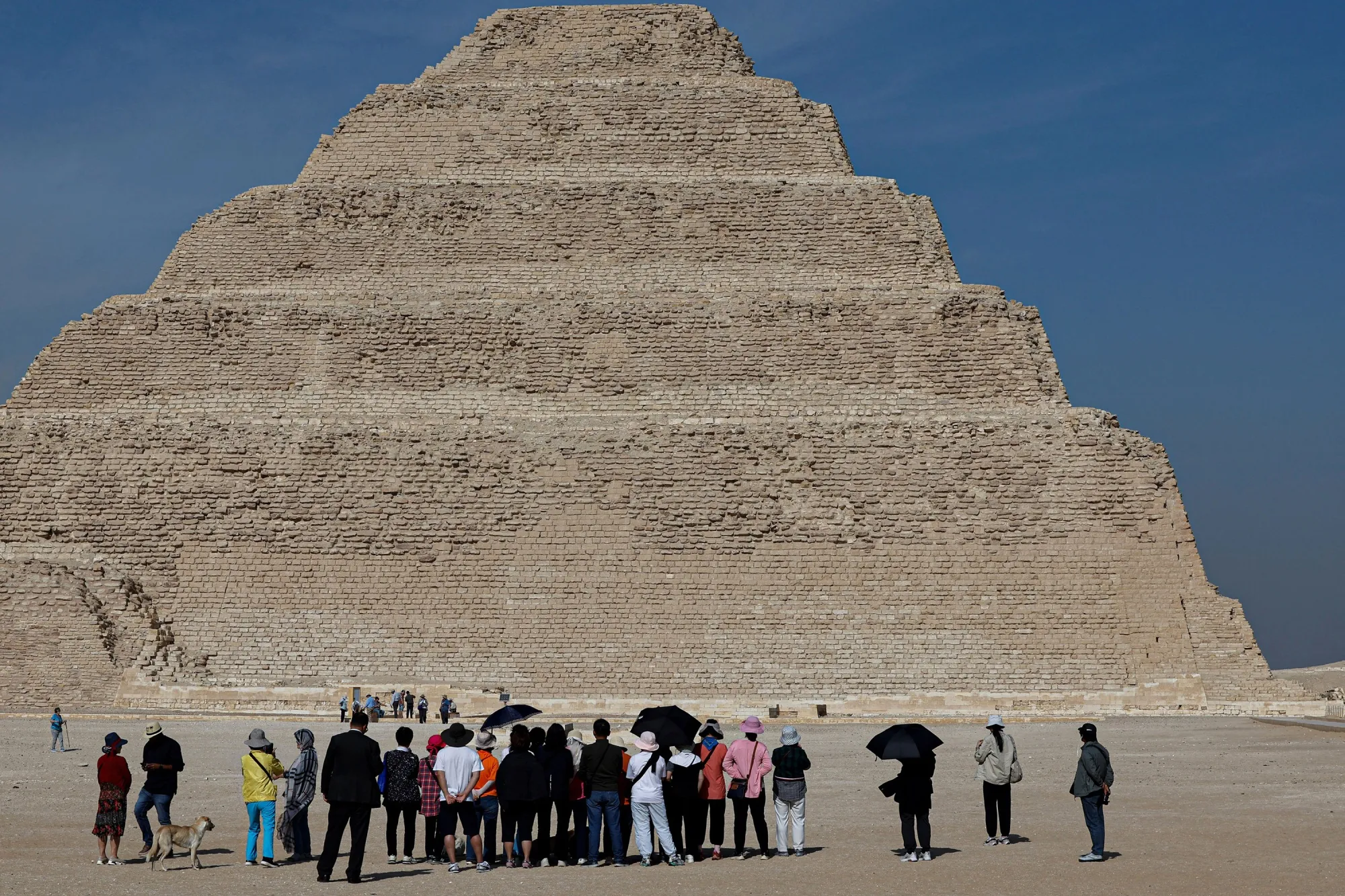 Tourists visit the site of a pyramid at the Saqqara Necropolis south Cairo, Egypt.